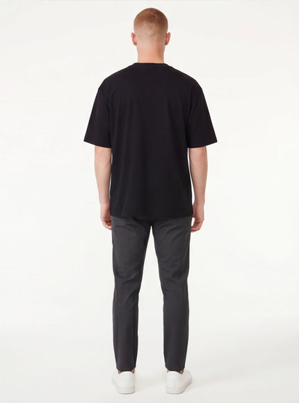 Model wearing Black applique badge graphic tee by Grozavu