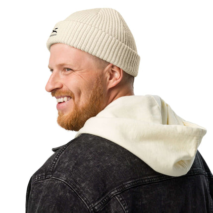 Man wearing a Grozavu beanie with a hoodie, showcasing cozy style and warmth in chilly weather.