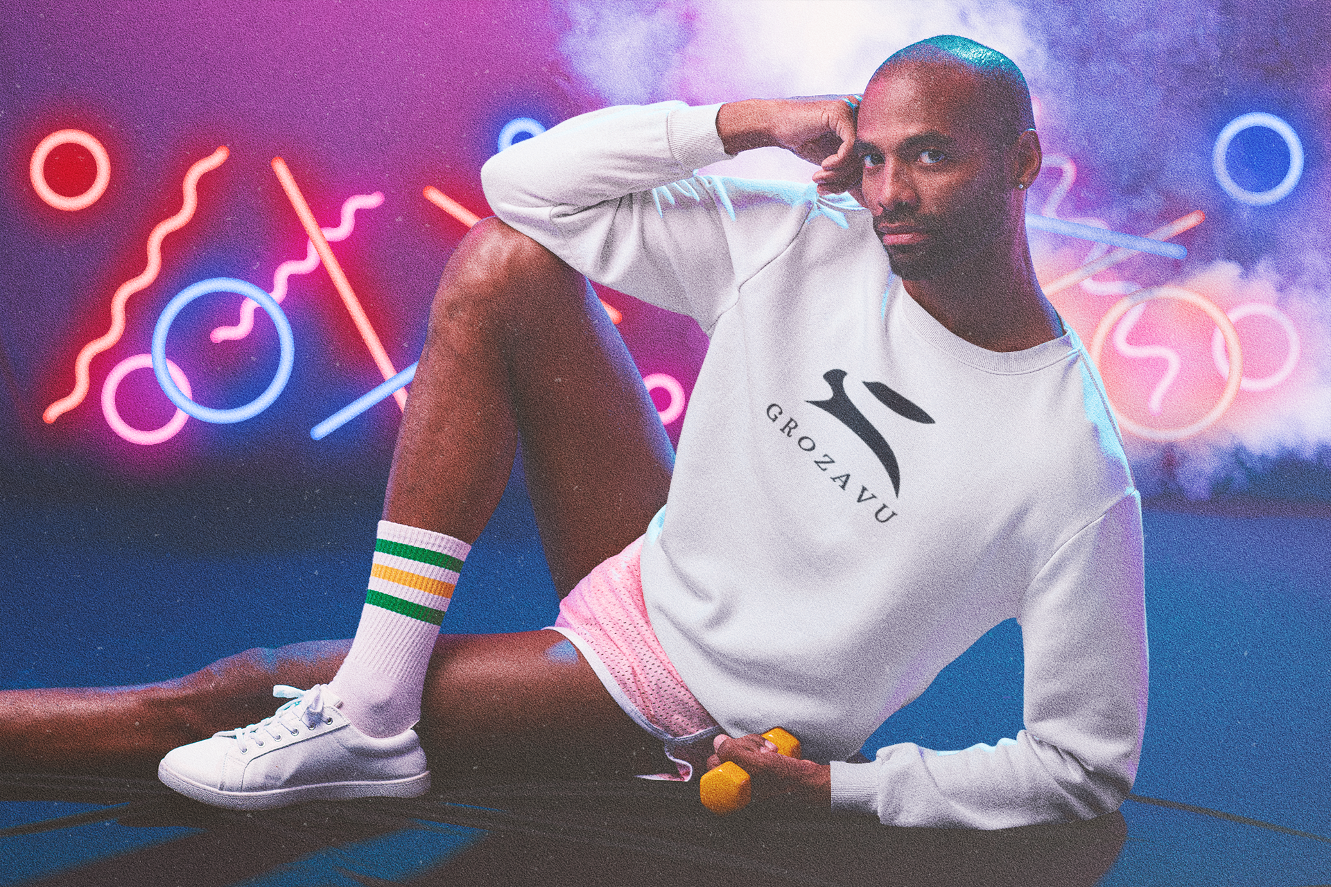 Male model in neon 80s scene wears Grozavu white crewneck sweatshirt with oversized rabbit logo, relaxed streetwear fit, holding a dumbbell