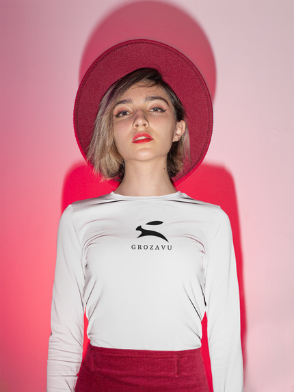 Woman wearing white Grozavu long-sleeve T-shirt with black rabbit logo, red hat studio portrait