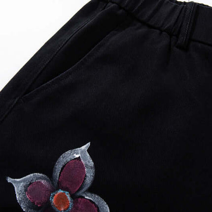 Graffiti Printed Cargo Denim Pants featuring hand-painted flower design on a black background.