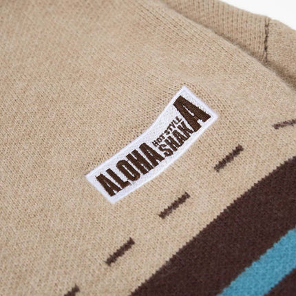 Close-up of the label on a High Neck Stripe Jacquard Cardigan showcasing ALOHA branding.