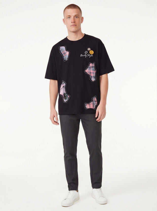 Model wearing Black applique badge graphic tee by Grozavu