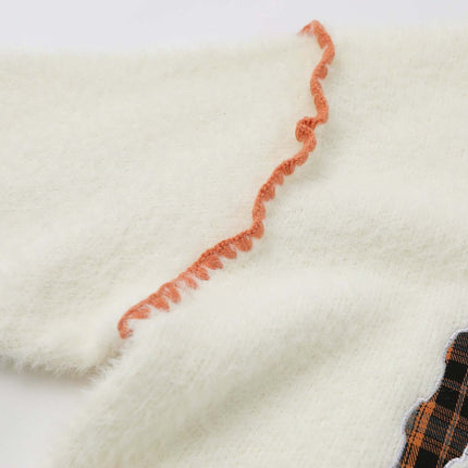 Knit Sweater with Letter Applique featuring a detailed ruffle on the sleeve and hand-stitched design.