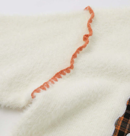 Knit Sweater with Letter Applique featuring a detailed ruffle on the sleeve and hand-stitched design.