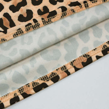 Close-up of fabric texture featuring the Leopard Print Strapless Crop Tank Top with detailed leopard patterns.