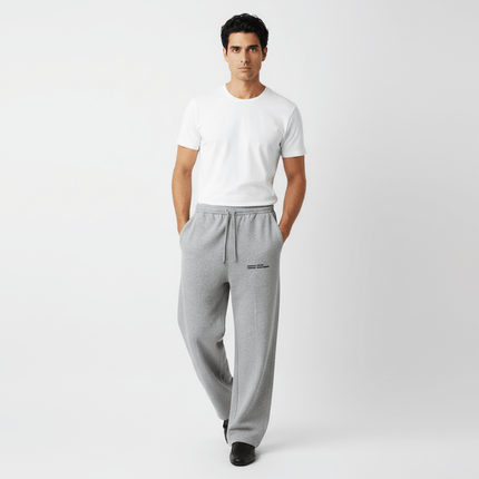 Model wearing Letter Print Casual Pants – Loose Fit with a white t-shirt, showcasing a relaxed and stylish look.