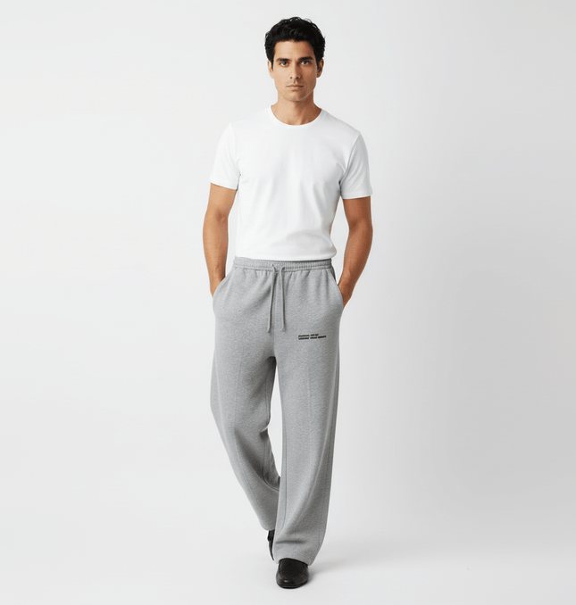 Model wearing Letter Print Casual Pants – Loose Fit with a white t-shirt, showcasing a relaxed and stylish look.