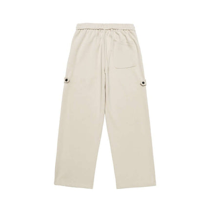 Letter Print Casual Pants – Loose Fit in beige, featuring an elastic waistband and side pockets.