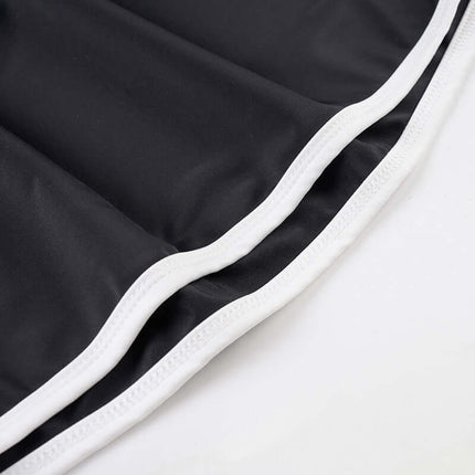 Long Sleeve Halter Neck Contrast Top fabric close-up featuring black material with white trim.