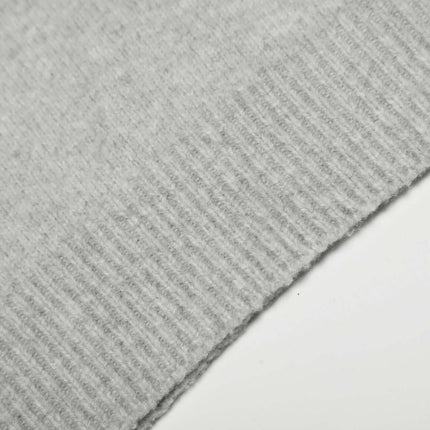 Loose Buttoned Turn Down Collar Sweater close-up texture of soft polyester knit fabric in light gray.