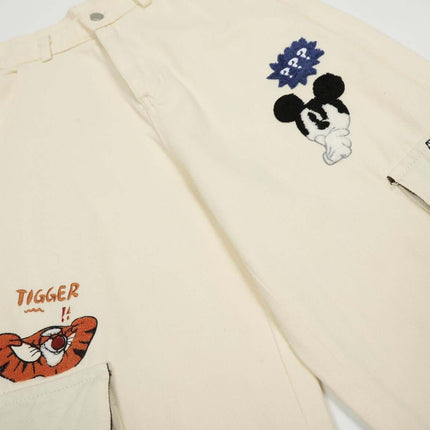 Loose Fit Cartoon Patchwork Pants featuring colorful cartoon embroidery and playful patchwork details.