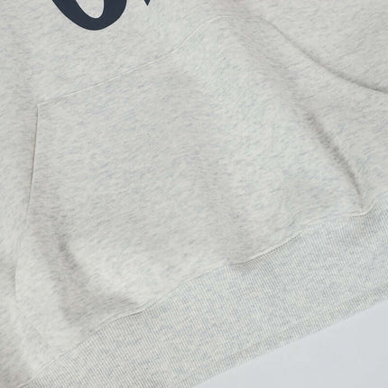 Close-up detail of the Oversized Hooded Sweatshirt – Loose Fit in White Flower Gray fabric with pocket.