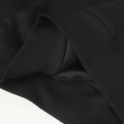 Detail of the fabric and stitching of the Oversized Hooded Sweatshirt – Loose Fit in black.