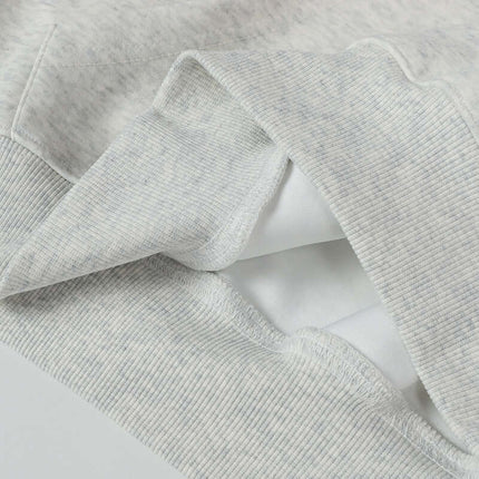 Close-up of the fabric details of an Oversized Hooded Sweatshirt – Loose Fit in light gray.