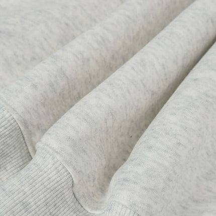 Close-up of the fabric texture of an Oversized Hooded Sweatshirt – Loose Fit in a soft light gray color.