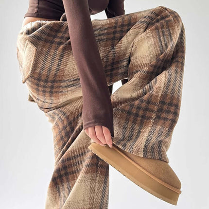 Model showcasing stylish Plaid Flannel Fleece Lined Winter Pants in a trendy outfit.