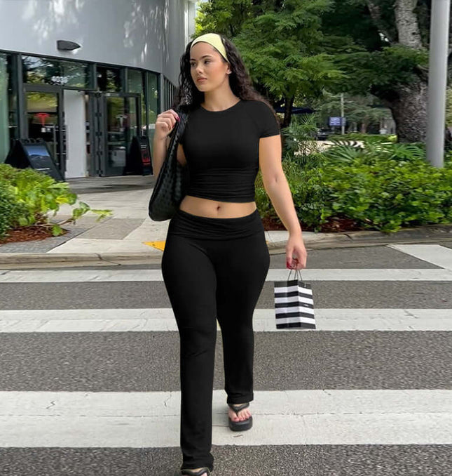 Pleated Short Sleeve Pants Set – Loose Fit worn by a woman in black on a city street with stylish accessories.