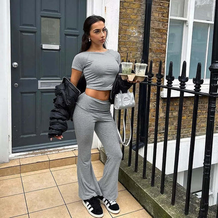 Woman wearing a Pleated Short Sleeve Pants Set – Loose Fit in gray, styled for casual street style with drinks in hand.