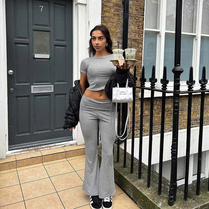 Stylish woman wearing Pleated Short Sleeve Pants Set – Loose Fit in gray, holding drinks on a city street.