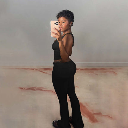 Model wearing Pleated Vest Two-Piece Set – Loose Fit, showcasing a sleek silhouette in casual black. Perfect for any occasion.