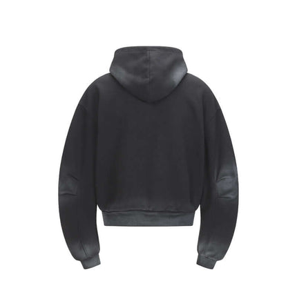 Back view of the Patchwork Half-Zip Hoodie showcasing its hood and cropped design in a solid color.