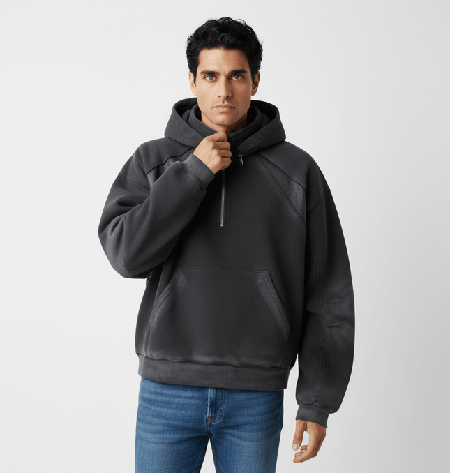Model wearing a Patchwork Half-Zip Hoodie in dark color, showcasing a stylish half-zip design and relaxed fit.