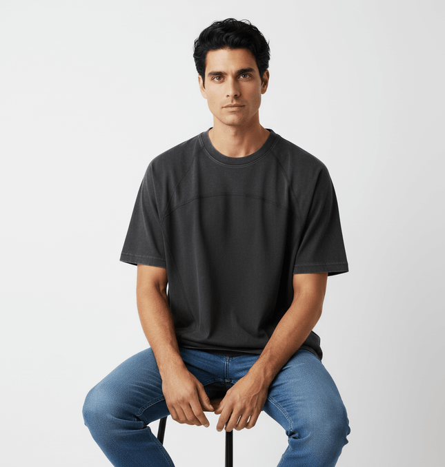 Retro Washed Letter Print TShirt – Loose Fit worn by a model sitting on a stool, styled with casual jeans.