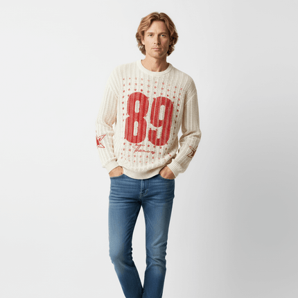 Model wearing a Round Neck Jacquard Knit Sweater with a red number 89 design, styled with blue jeans.