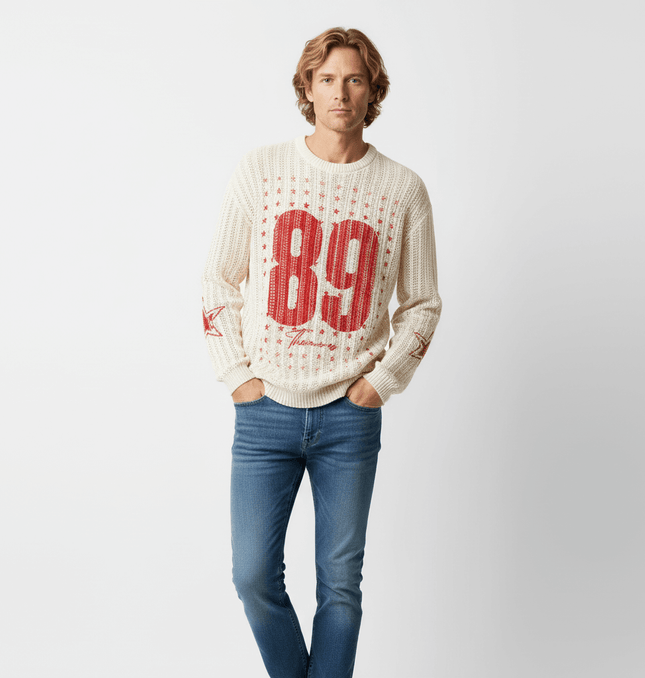 Model wearing a Round Neck Jacquard Knit Sweater with a red number 89 design, styled with blue jeans.