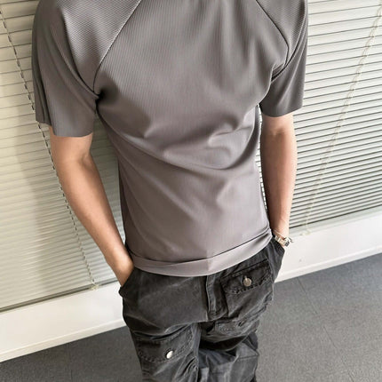Seamless Jacquard TShirt – Loose Fit in gray worn by a man with casual pants, showcasing modern athletic style.