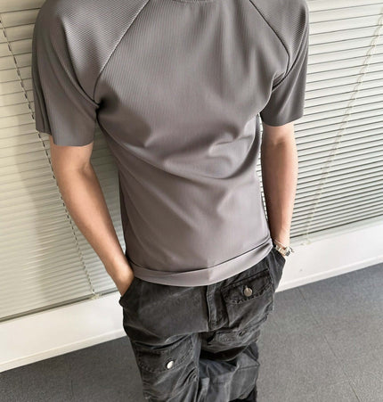 Seamless Jacquard TShirt – Loose Fit in gray worn by a man with casual pants, showcasing modern athletic style.