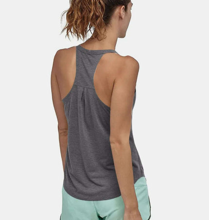 Model wearing a Slim Fit Cotton Scoop Neck Tank Top with back view, paired with stylish shorts.