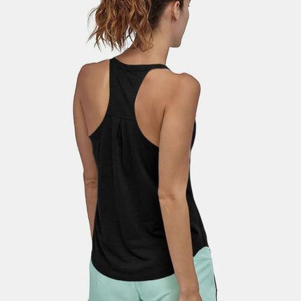Slim Fit Cotton Scoop Neck Tank Top in black, back view, paired with light green shorts for active wear.