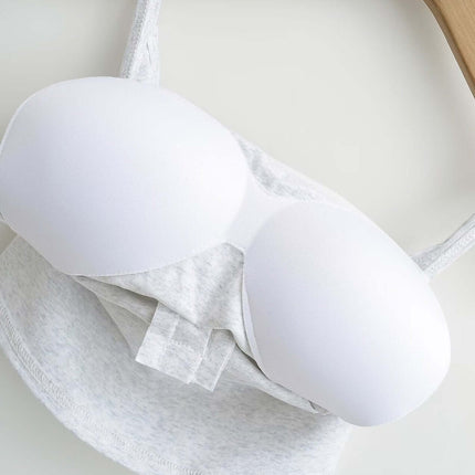 Lace Strap Button Tank Top - Slim Fit with lace straps and built-in chest cushion on a wooden hanger.