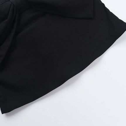 Close-up of the fabric and bow detail of the Slim Fit One-Shoulder Bow Top in black.