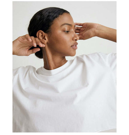 Sport Crop Cotton Top - Loose Fit modeled by a woman with a round neckline in a casual setting.