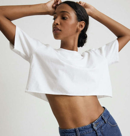 Sport Crop Cotton Top - Loose Fit modeled by a young woman showing a cropped silhouette in a stylish and casual manner.
