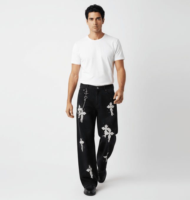 Fashion model wearing Straight Leg Patchwork Denim Jeans featuring cross patch embroidery and color splatter detailing.