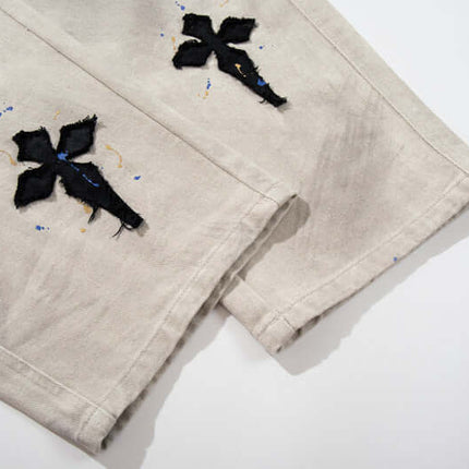 Straight Leg Patchwork Denim Jeans featuring cross patch embroidery and hand-painted color splatter detailing.