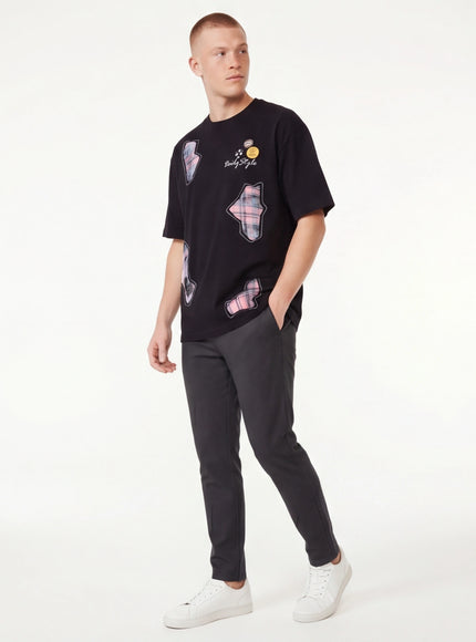 Close-up of Black applique badge graphic tee fabric
