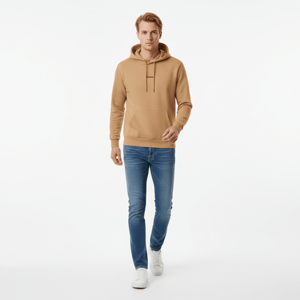 Urban Garment Dyed Hoodie – Loose Fit shown on a model walking, paired with jeans and sneakers.