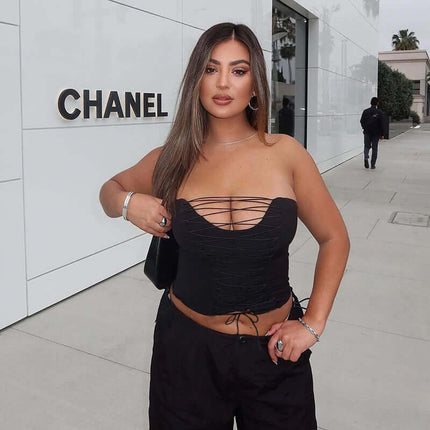 VNeck Cross Hollow Strapless Top – Slim Fit worn with stylish black pants outside a Chanel store.