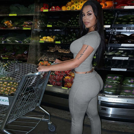 Pleated Short Sleeve Pants Set – Loose Fit worn by a woman in a grocery store aisle with fresh produce.