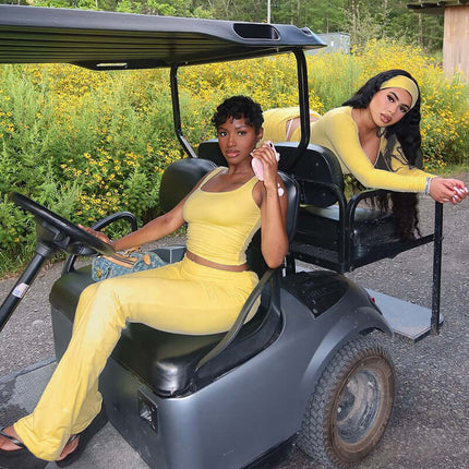 Pleated Vest Two-Piece Set – Loose Fit worn by two women in yellow on a golf cart surrounded by flowers.