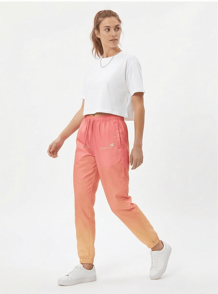 Model wearing relaxed track trousers by Grozavu