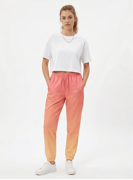 Model wearing relaxed track trousers by Grozavu